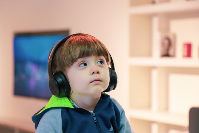 An autistic child wears ear muffs to reduce noise. 