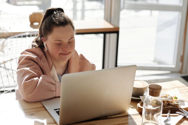 Young adult with special needs uses a computer